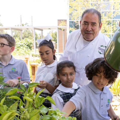 Emeril in garden with student children