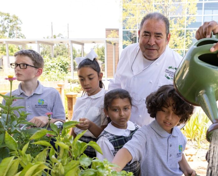 Emeril in garden with student children