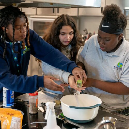 Kids and teens working in a culinary education program