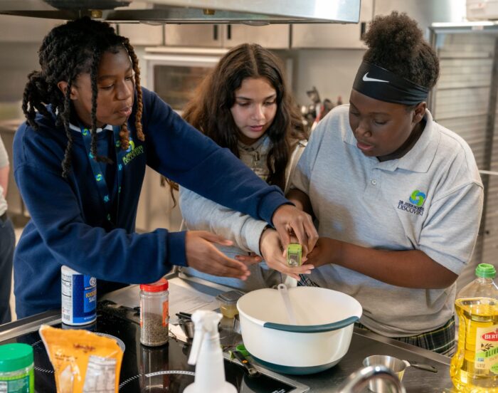 Kids and teens working in a culinary education program