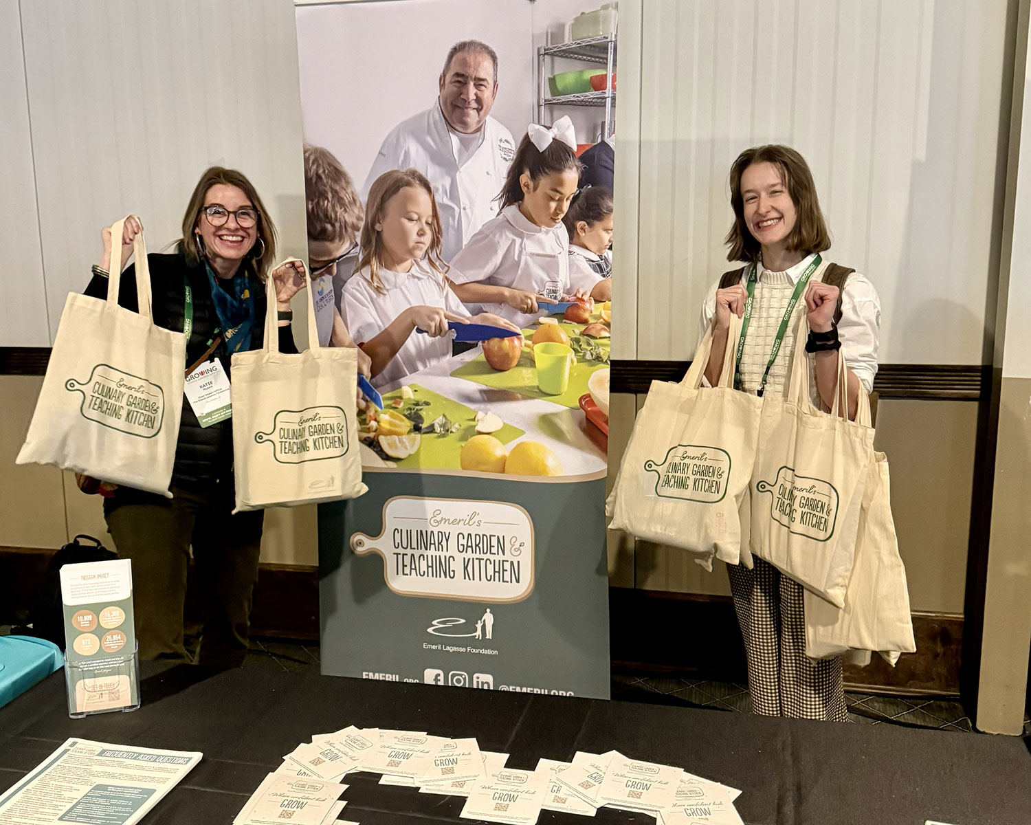 2 Woman standing next to a standup banner