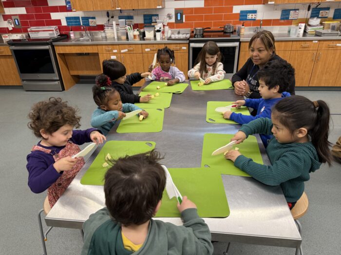 School children engaged in seed-to-table learning.